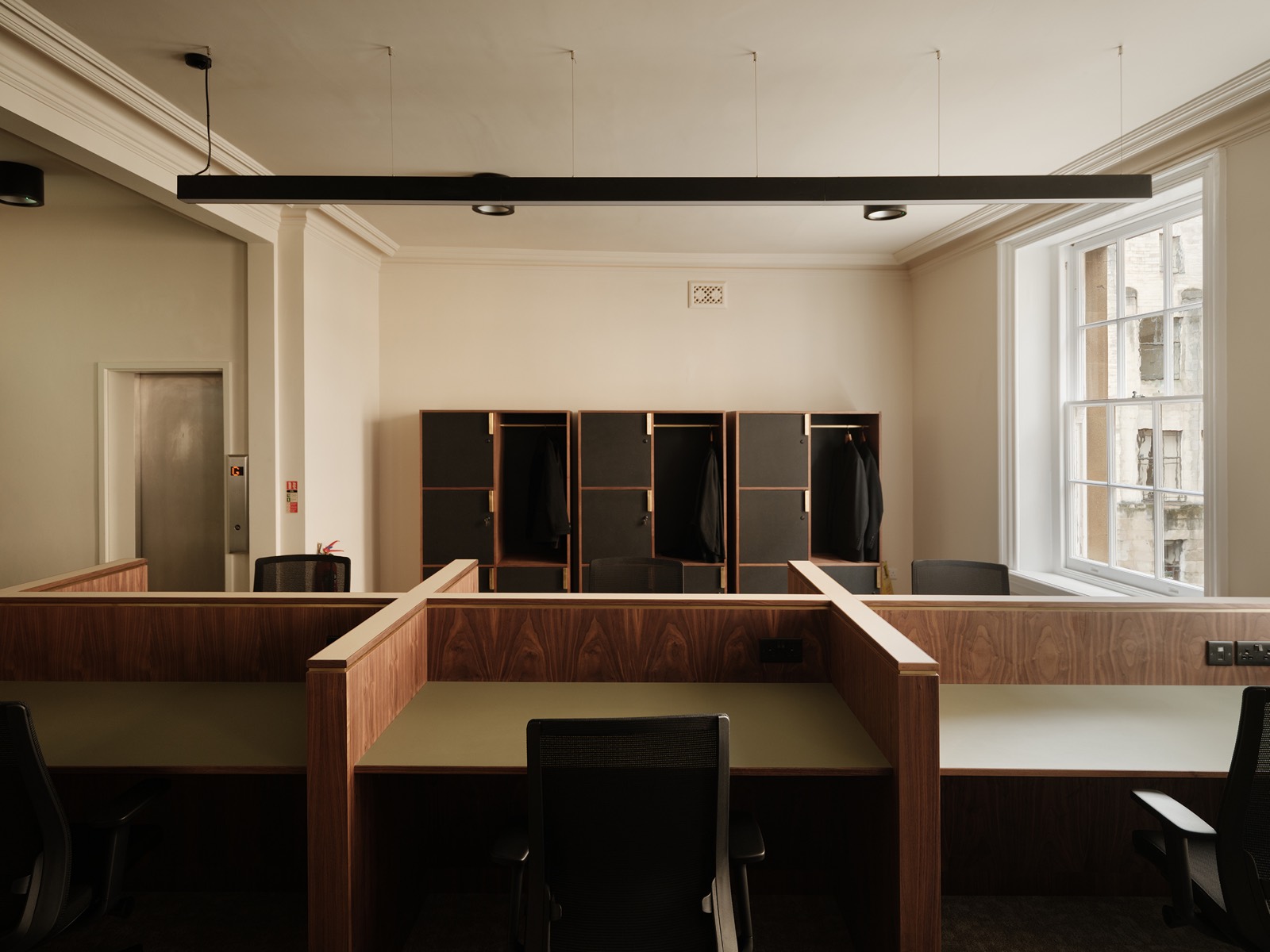 Walnut desk booths in the co-working office