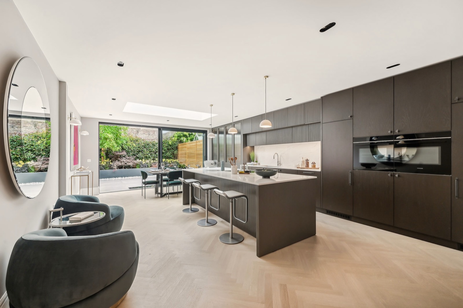 The kitchen and dining room in the rear extension, glazed to the garden