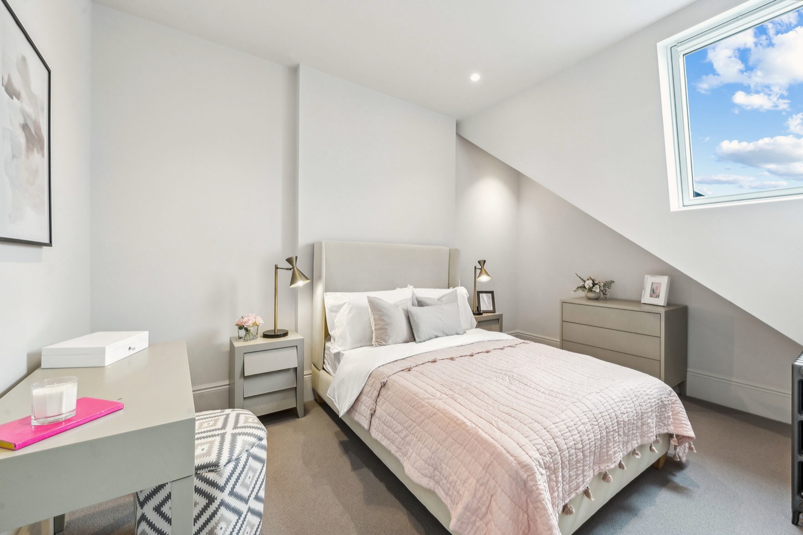 A bedroom in the roof, under a rooflight
