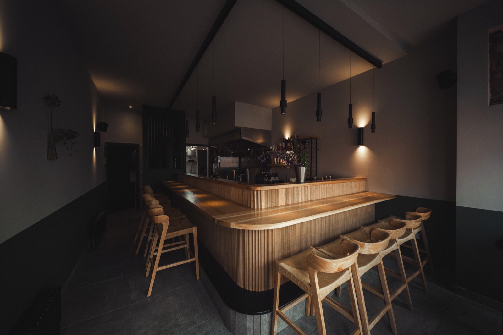 The timber counter and its stools, wrapped around the open kitchen